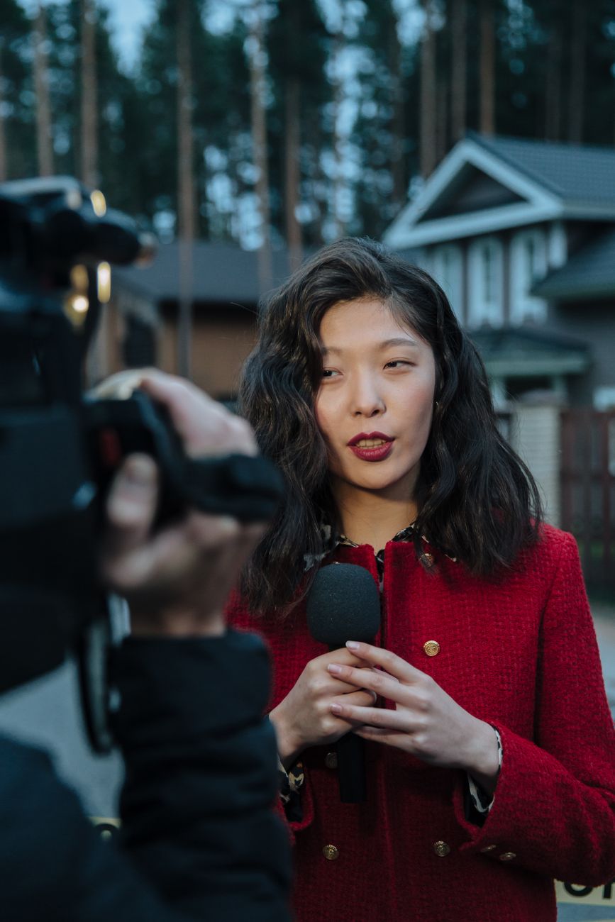 Professional news anchor interviewing with a microphone